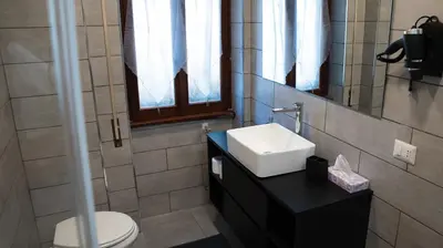 a bathroom with a white sink and a toilet at B&B La Terrazza sui Colli in Rome