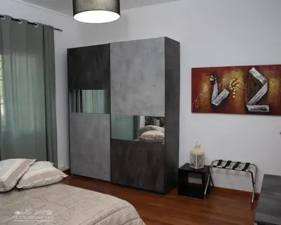 a bedroom with a bed and a painting on the wall at B&B La Terrazza sui Colli in Rome