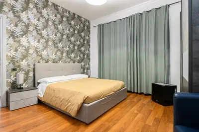a bedroom with a bed and a floral wall at B&B La Terrazza sui Colli in Rome