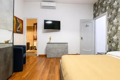a bedroom with a bed and a television on a wall at B&B La Terrazza sui Colli in Rome