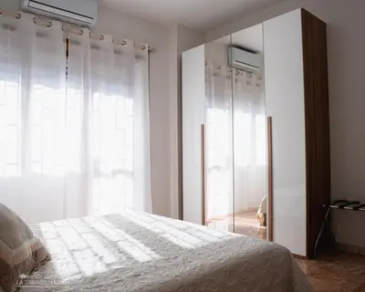 a bedroom with a bed and a large window at B&B La Terrazza sui Colli in Rome