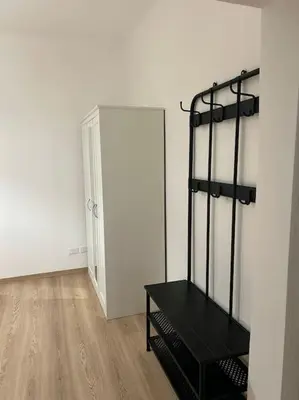 an empty room with a black shelf in the corner at Caroline Home in Rome