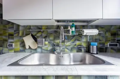 a stainless steel sink in a kitchen at Angi's home the new Luxury in Rome heart in Rome