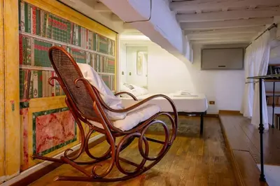 a rocking chair sitting in the corner of a room at Angi's home the new Luxury in Rome heart in Rome