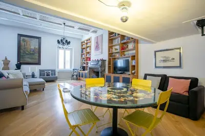 a living room with a glass table and yellow chairs at Angi's home the new Luxury in Rome heart in Rome
