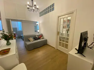 a living room with a couch and a television at Le mongolfiere in Rome