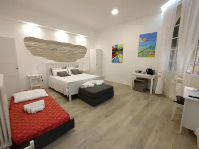 a bedroom with a bed and a couch in it at Malila's-Cipitelli Trevi in Rome