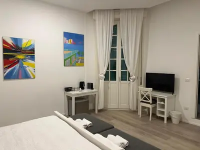 a bedroom with a bed and a tv and a desk at Malila's-Cipitelli Trevi in Rome