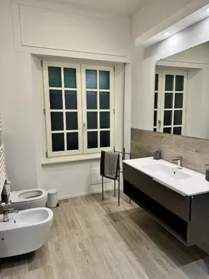 a bathroom with two sinks and a tub and a toilet at Malila's-Cipitelli Trevi in Rome