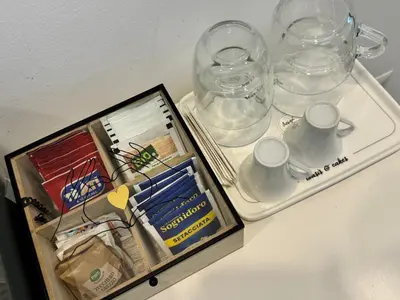a tray with cups and glasses on a table at Malila's-Cipitelli San Pietro in Rome