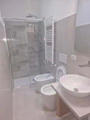 a bathroom with a shower and a toilet and a sink at Relux Pretoria Rooms in Rome