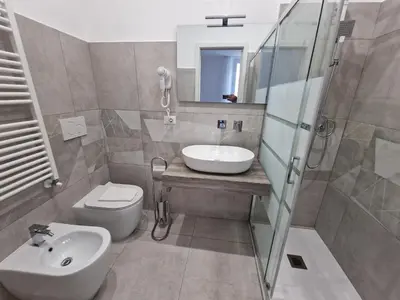 a bathroom with a sink and a toilet and a shower at Relux Pretoria Rooms in Rome