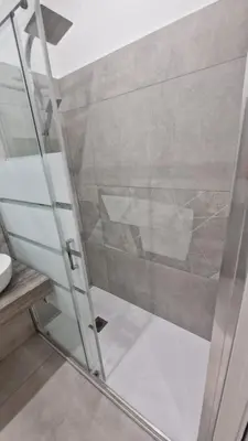 a shower with a glass door in a bathroom at Relux Pretoria Rooms in Rome