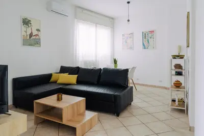 a living room with a black couch and a coffee table at Rooftop Apartment Quadraro in Rome