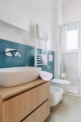 a bathroom with a sink and a tub and a toilet at Rooftop Apartment Quadraro in Rome