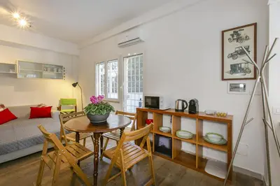 a living room with a table and chairs and a bed at Arbia Stay in Rome