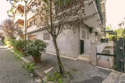 a small tree on a sidewalk next to a building at Arbia Stay in Rome