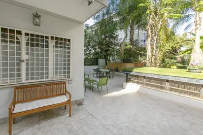 an outdoor patio with a bench and a table at Arbia Stay in Rome