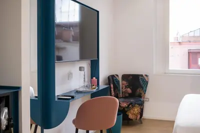 a room with a desk and a chair and a mirror at Bhr Brancaccio 83 in Rome