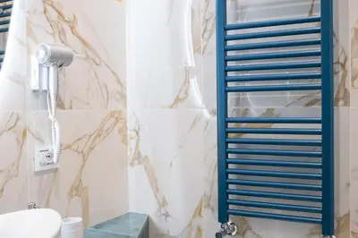 a bathroom with a blue towel rack next to a toilet at Bhr Brancaccio 83 in Rome