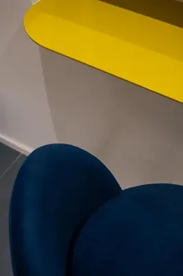 a blue chair sitting next to a yellow table at Bhr Brancaccio 83 in Rome