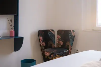 a chair sitting in the corner of a room at Bhr Brancaccio 83 in Rome