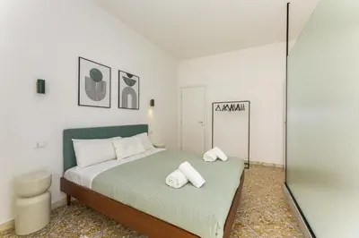a bedroom with a bed with two towels on it at NiMa Holiday 49 in Rome