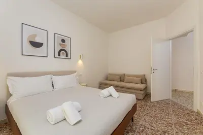 a bedroom with a bed with towels on it at NiMa Holiday 49 in Rome