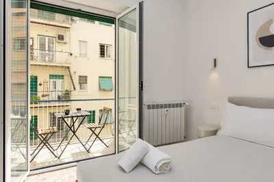 a bedroom with a bed and a large window at NiMa Holiday 49 in Rome