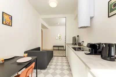 a kitchen and living room with a counter top at NiMa Holiday 49 in Rome