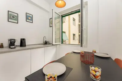 a kitchen with a table and chairs and a window at NiMa Holiday 49 in Rome