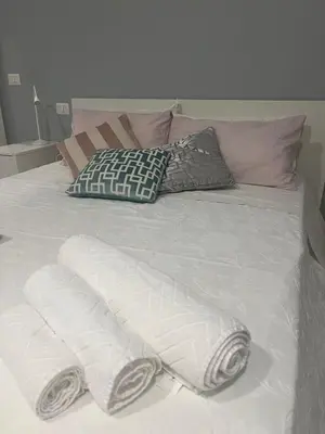 a bed with two white towels and pillows on it at Malila's - Cipitelli Spagna in Rome