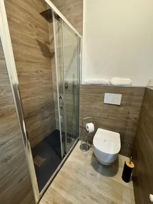 a bathroom with a toilet and a glass shower at Malila's - Cipitelli Spagna in Rome