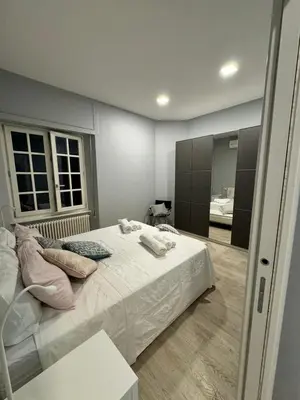 a bedroom with a large bed and a mirror at Malila's - Cipitelli Spagna in Rome