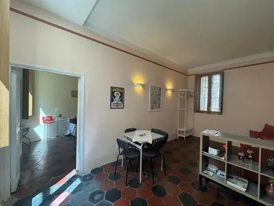 a living room with a table and chairs in it at Le Due Torri in Rione Monti in Rome