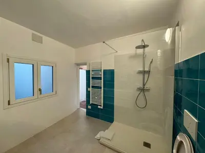 a bathroom with a shower and a toilet and a window at Le Due Torri in Rione Monti in Rome