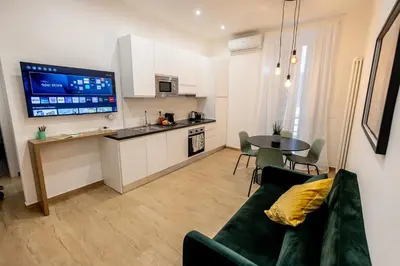 a kitchen with a picture of a forest on the wall at Re di Roma Ela Apartment in Rome