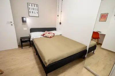 a small bed in a room with a mirror at Re di Roma Ela Apartment in Rome