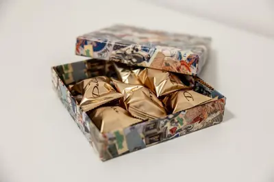 two boxes filled with wrapping paper on a white background at Re di Roma Ela Apartment in Rome