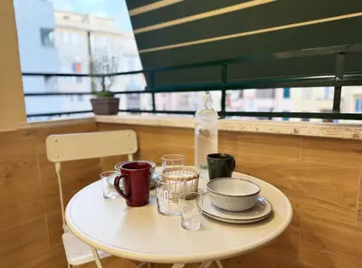 a white table with cups and glasses on it at Dima Home Cute Flat in Rome in Rome