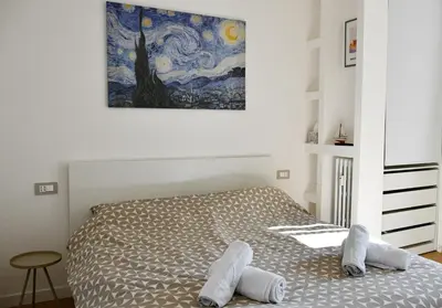 a bedroom with a bed and a painting on the wall at Dima Home Cute Flat in Rome in Rome