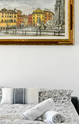 a painting hanging above a bed in a bedroom at Dima Home Cute Flat in Rome in Rome