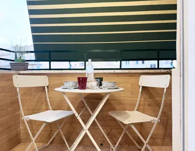 a white table and two chairs in a room at Dima Home Cute Flat in Rome in Rome