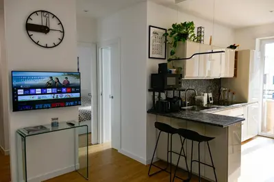 a kitchen with a counter and a clock on the wall at Dima Home Cute Flat in Rome in Rome
