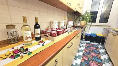 a kitchen with bottles of wine on a counter at Casa Simpatia Roma Vaticano in Rome
