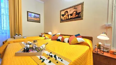 two twin beds in a room with yellow sheets at Casa Simpatia Roma Vaticano in Rome
