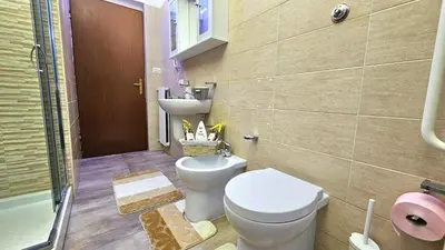 a bathroom with a toilet and a sink at Casa Simpatia Roma Vaticano in Rome