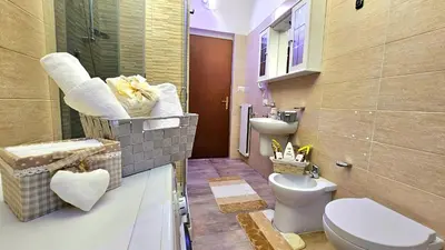 a bathroom with a toilet and a sink at Casa Simpatia Roma Vaticano in Rome
