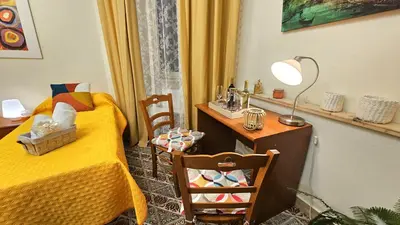 a bedroom with a bed and a table with a lamp at Casa Simpatia Roma Vaticano in Rome