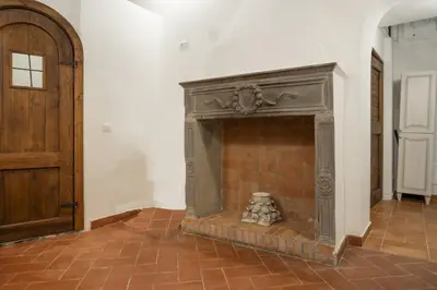 a fireplace in a room with a wooden door at Home Domus Capocci - Rione Monti in Rome